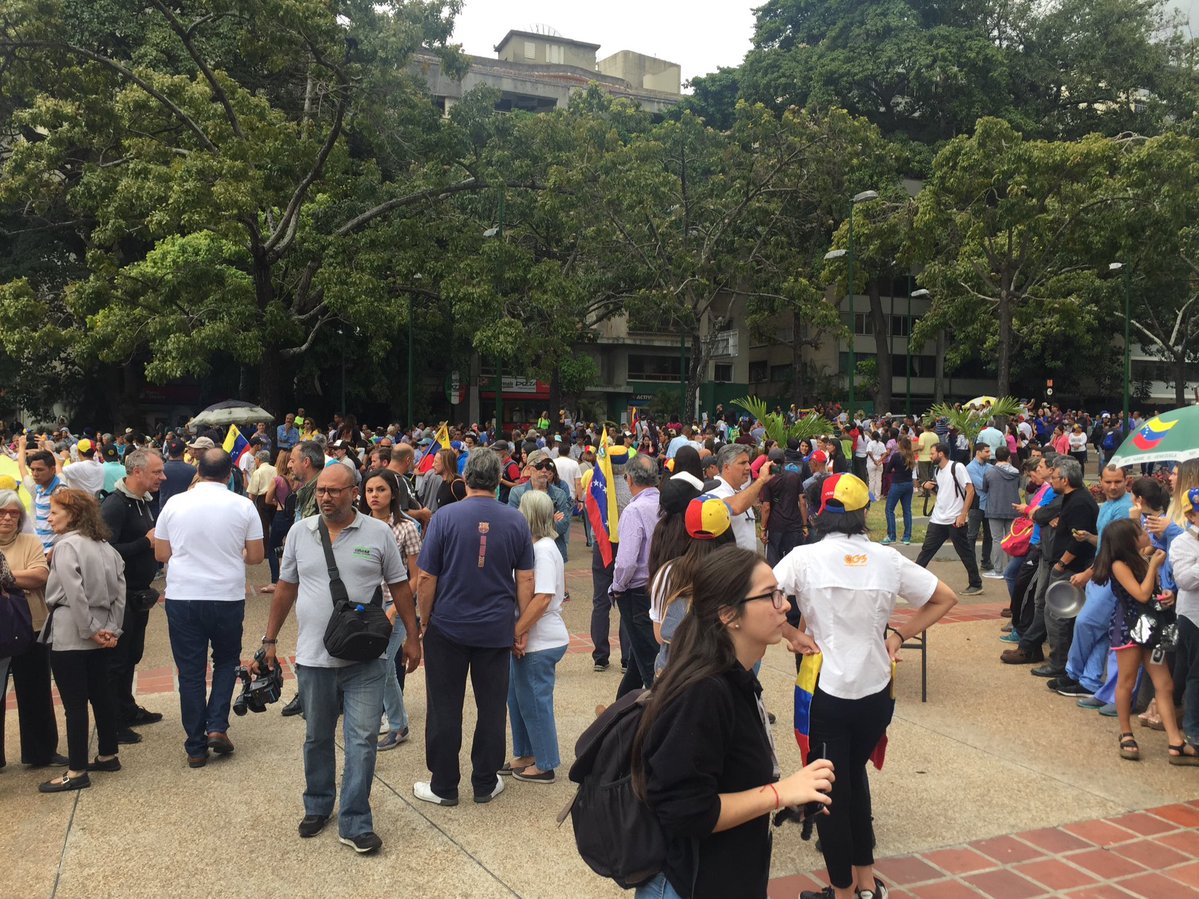 People begin to gather at Plaza Altamira in Caracas