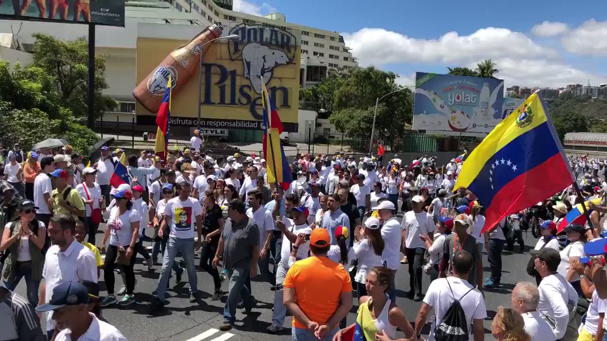 This is the scene in Caracas. Thousands are headed to La Carlota, the military airfield in the middle of the city. They will demand that the military takes the side of opposition leader Juan Guaido.   