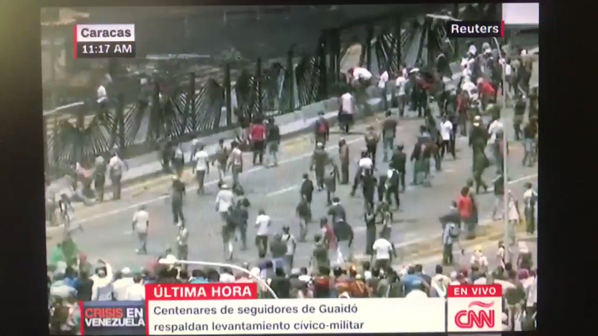 Protesters made a hole in the fence of La Carlota Air Base