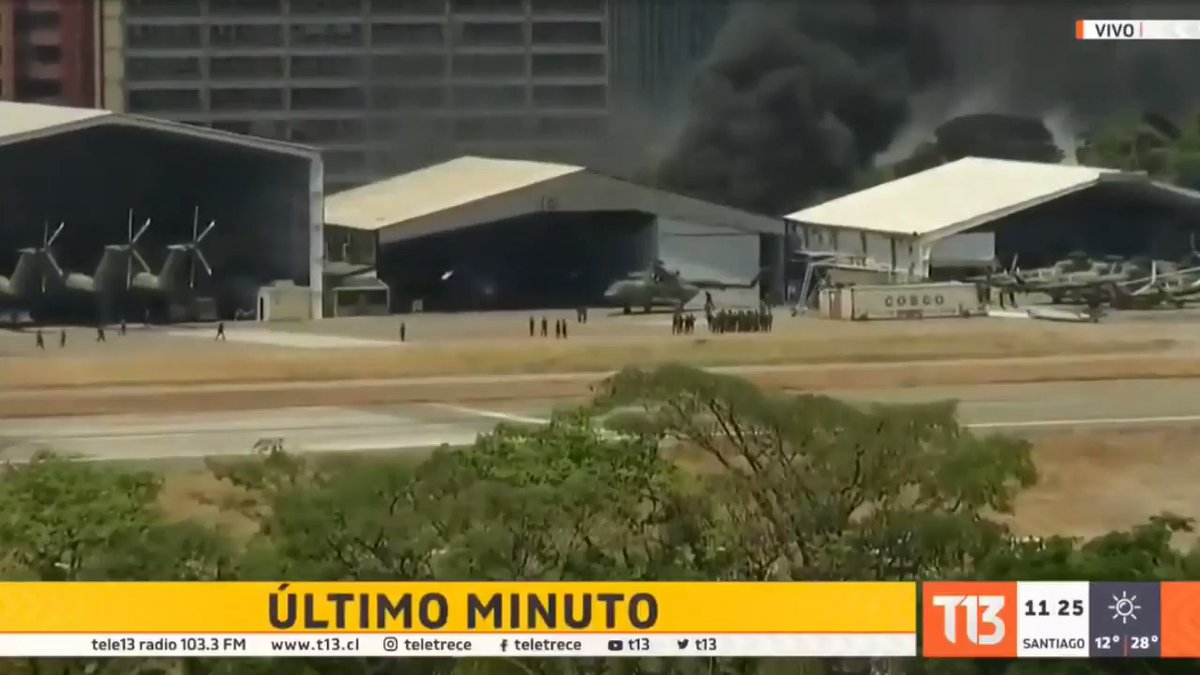 La Carlota: Thick, black smoke rising from behind a hangar. Venezuela   