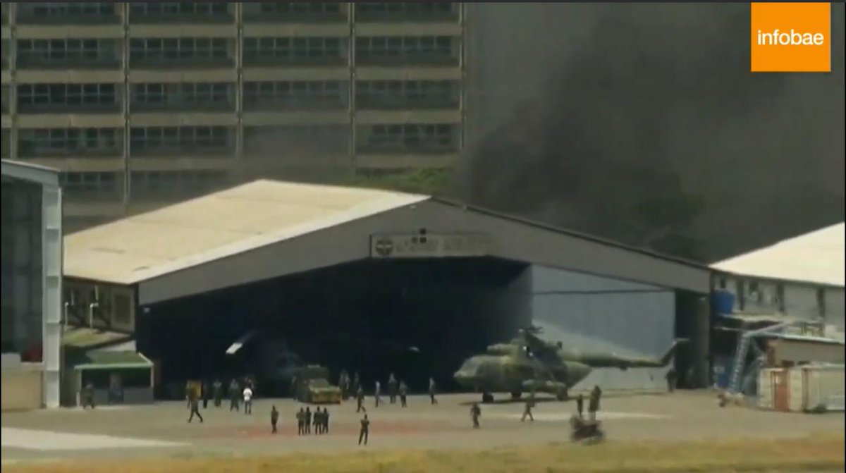 Fire at La Carlota Air Base, soldiers tow MI helicopter to protect it from fire in one of the hangars inside the air base.