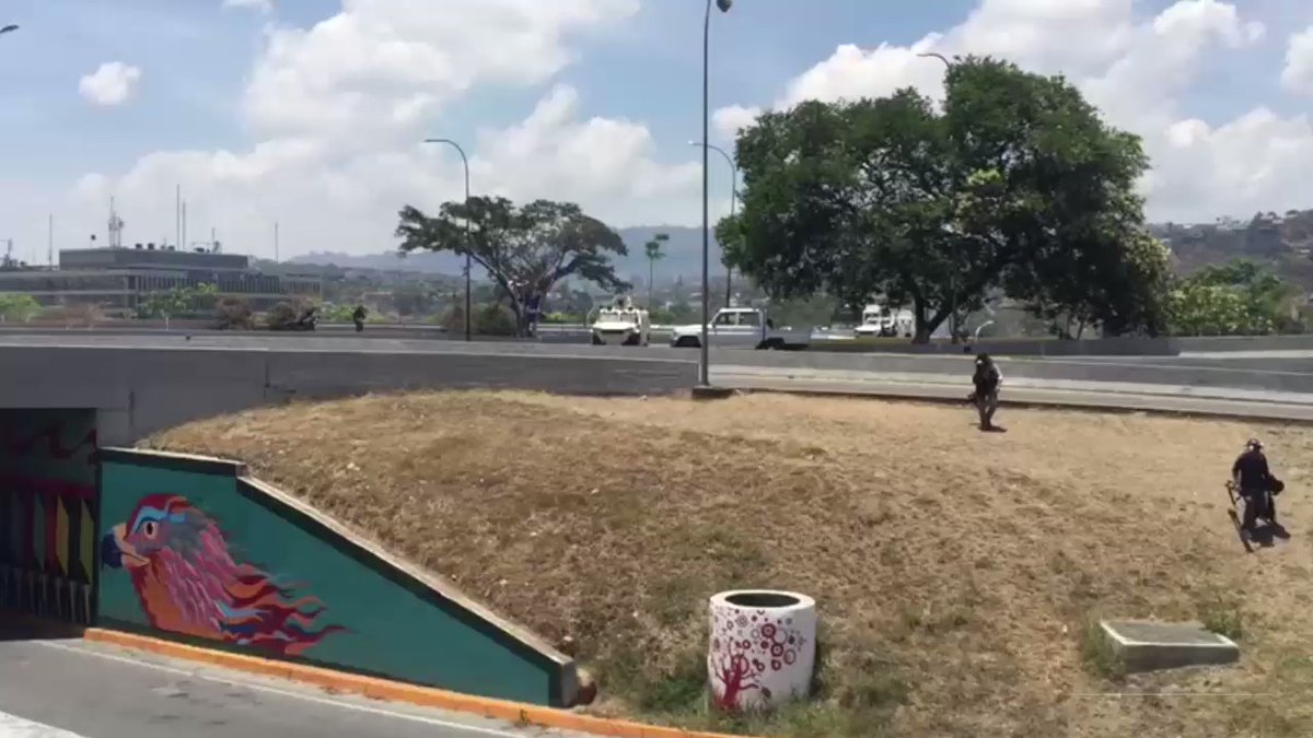 Armored vehicle of the National Guard ramming into van of @jguaido rebels near La Carlota, gunfire following