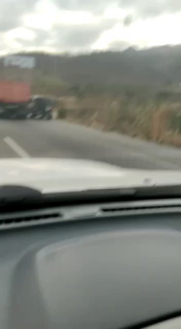 Security forces shooting at gang members in the hills as they drive down the highway in Las Tejerías, Aragua Venezuela