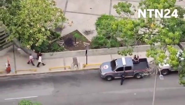 Police agents take journalist Carmela Longo and her son from their home in Caracas