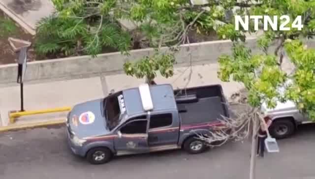 Police agents take journalist Carmela Longo and her son from their home in Caracas