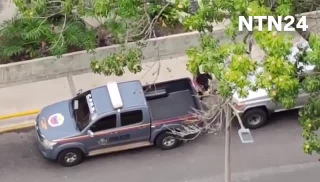 Police agents take journalist Carmela Longo and her son from their home in Caracas