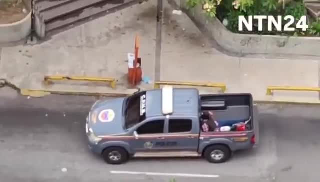 Police agents take journalist Carmela Longo and her son from their home in Caracas